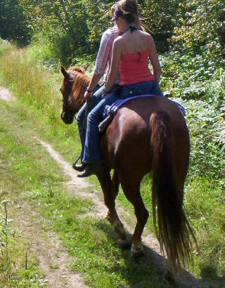 Two girls riding double