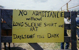 Sign on rodeo gate requiring long sleeve shirts