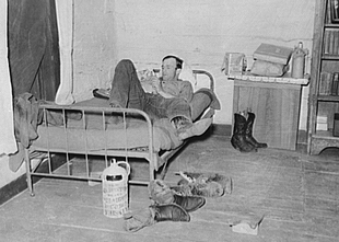 Cowboy relaxing on his bed in the ranch bunkhouse