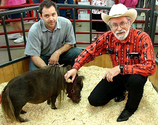 Cowboy Bob holds a walnut next to Thumbelina's head