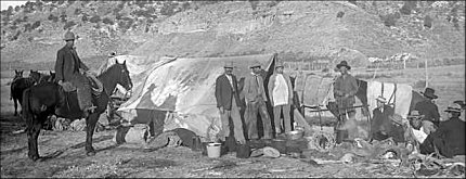 A group of cowboys on a cattle drive ready to break camp