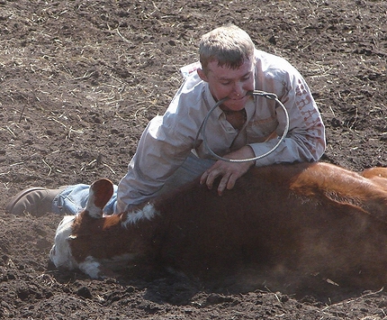 Cowboy with a piggin' string in his teeth