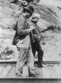 Two hobos walking along railroad tracks, after being put off a train