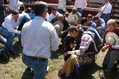 A sky pilot praying with rodeo cowboys