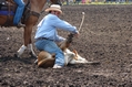 Calf roper tying a hooey