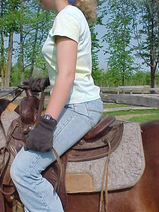 Sitting up moves rider's rear away from the cantle